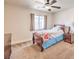 This bedroom offers a ceiling fan, window, nightstand, and neutral carpet at 1332 Cedar Berry Ct, Henderson, NV 89012