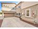 View of attached garage and side yard of the home with desert landscaping at 1332 Cedar Berry Ct, Henderson, NV 89012