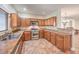 Well-equipped kitchen featuring stainless steel appliances, granite countertops, and wood cabinetry at 1332 Cedar Berry Ct, Henderson, NV 89012