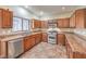 Spacious kitchen features stainless steel appliances, granite countertops, and wood cabinets at 1332 Cedar Berry Ct, Henderson, NV 89012