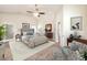 Bright main bedroom featuring a ceiling fan, neutral tones, and a private ensuite at 1332 Cedar Berry Ct, Henderson, NV 89012