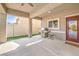 Covered patio features a built-in grill, concrete flooring, and convenient access to the backyard at 1332 Cedar Berry Ct, Henderson, NV 89012