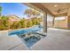 A backyard pool with a spa and lounge chairs with a covered patio at 1332 Cedar Berry Ct, Henderson, NV 89012
