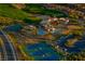 Aerial view of the community's club house, pool, tennis court and other amenities amidst lush landscaping at 14 Heron Harbour Dr, Henderson, NV 89011