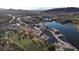 An aerial view of luxury homes and a golf course bordering a scenic lake at 14 Heron Harbour Dr, Henderson, NV 89011