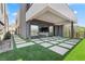 Modern outdoor space featuring artificial grass, pavers, and an expansive sliding door, offering a seamless indoor-outdoor transition at 14 Heron Harbour Dr, Henderson, NV 89011