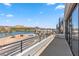 Expansive balcony offering stunning views of the lake, mountains, and the modern homes nearby, with spiral staircase access at 14 Heron Harbour Dr, Henderson, NV 89011