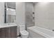 Modern bathroom with a sleek vanity, tiled bathtub, and contemporary fixtures at 14 Heron Harbour Dr, Henderson, NV 89011