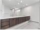 Modern bathroom featuring a large vanity with double sinks, custom cabinetry and an expansive mirror at 14 Heron Harbour Dr, Henderson, NV 89011