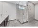 Contemporary bathroom featuring gray tile and a glass-enclosed shower with a modern sink and faucet at 14 Heron Harbour Dr, Henderson, NV 89011