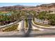 An aerial view captures the beauty of Lake Las Vegas entrance with lush landscaping and scenic roads at 14 Heron Harbour Dr, Henderson, NV 89011