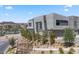 Contemporary home showcasing modern design with clean lines, lake view and desert landscaping enhancing curb appeal at 14 Heron Harbour Dr, Henderson, NV 89011