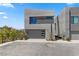 Modern exterior with a stucco siding and a two-car garage at 14 Heron Harbour Dr, Henderson, NV 89011