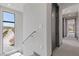 Bright hallway with a large window showcasing the exterior landscape and neighborhood at 14 Heron Harbour Dr, Henderson, NV 89011