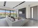 Modern living room with large windows showcasing lake views and a sleek entertainment center at 14 Heron Harbour Dr, Henderson, NV 89011