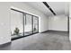 Minimalist living room with tile flooring, recessed lighting, and large windows showcasing outdoor greenery at 14 Heron Harbour Dr, Henderson, NV 89011