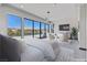 Bedroom featuring waterfront views, modern furniture, and a private balcony at 14 Heron Harbour Dr, Henderson, NV 89011