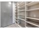 Walk-in pantry with custom shelving and ample storage space at 14 Heron Harbour Dr, Henderson, NV 89011