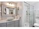 Updated bathroom with a stone sink, large mirror and glass-enclosed shower at 1404 Colony Pine St, Las Vegas, NV 89144