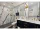 Modern bathroom with a glass shower, white marble and navy blue vanity at 1404 Colony Pine St, Las Vegas, NV 89144