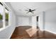 Bedroom featuring hard wood floors, a ceiling fan, and a large window at 1404 Colony Pine St, Las Vegas, NV 89144