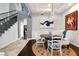 Formal dining room featuring wainscoting, chandelier lighting and access to the main staircase at 1404 Colony Pine St, Las Vegas, NV 89144