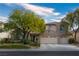 Charming two-story home with mature landscaping, neutral stucco, and a three-car garage at 1404 Colony Pine St, Las Vegas, NV 89144