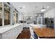 Beautiful white kitchen features marble countertops, stainless steel appliances, and a butcher block island at 1404 Colony Pine St, Las Vegas, NV 89144