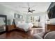 Bright main bedroom featuring hardwood floors, ceiling fan, sitting area and an ensuite bathroom at 1404 Colony Pine St, Las Vegas, NV 89144