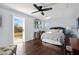 Bright main bedroom featuring hardwood floors, ceiling fan and balcony access at 1404 Colony Pine St, Las Vegas, NV 89144