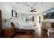 Bright main bedroom featuring hardwood floors, ceiling fan, sitting area and an ensuite bathroom at 1404 Colony Pine St, Las Vegas, NV 89144