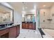 Luxurious bathroom featuring dual sinks, soaking tub, and glass-enclosed shower at 145 E Harmon Ave # 2008, Las Vegas, NV 89109