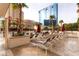 Beautiful pool area featuring many chairs and umbrellas, surrounded by palm trees at 145 E Harmon Ave # 2008, Las Vegas, NV 89109