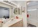 Bright bathroom with a vanity, dual mirrors, and a shower with a glass door at 1509 Linnbaker Ln # 203, Las Vegas, NV 89110