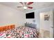 A well-lit bedroom features a ceiling fan, tv, grey dresser, and hard surface floors at 1509 Linnbaker Ln # 203, Las Vegas, NV 89110