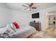 A bedroom with a television, dresser, and light grey floors and an open doorway at 1509 Linnbaker Ln # 203, Las Vegas, NV 89110