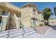 Inviting exterior view of a condo building with tan stucco, green railings, and well-maintained landscaping at 1509 Linnbaker Ln # 203, Las Vegas, NV 89110