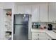 Open kitchen layout with a black refrigerator and a pantry with shelving at 1509 Linnbaker Ln # 203, Las Vegas, NV 89110