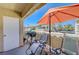 Relaxing outdoor patio with an umbrella, comfortable chairs, and a view of the neighborhood at 1509 Linnbaker Ln # 203, Las Vegas, NV 89110