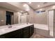 Bathroom with double sinks, soaking tub, glass shower, and large mirror at 1544 Karst Pond Ave, North Las Vegas, NV 89084