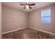 Cozy bedroom features a ceiling fan and plush carpeting at 1544 Karst Pond Ave, North Las Vegas, NV 89084