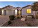 Single-story home featuring desert landscaping and ornate front door at 1544 Karst Pond Ave, North Las Vegas, NV 89084