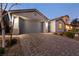 Home with a brick paver driveway leading to an attached two-car garage at 1544 Karst Pond Ave, North Las Vegas, NV 89084