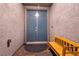 Covered entryway with a blue double-door and a wooden bench at 1544 Karst Pond Ave, North Las Vegas, NV 89084