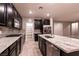 Kitchen with stainless appliances, granite countertops, grey backsplash, and walk-in pantry at 1544 Karst Pond Ave, North Las Vegas, NV 89084