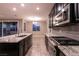 Kitchen features stainless steel appliances, granite countertops, grey backsplash, island sink at 1544 Karst Pond Ave, North Las Vegas, NV 89084