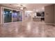 Open-concept living room features tile floors and sliding glass doors to covered patio at 1544 Karst Pond Ave, North Las Vegas, NV 89084