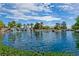 Scenic view of a tranquil community pond with a tiered rock waterfall and lush landscaping at 1544 Karst Pond Ave, North Las Vegas, NV 89084