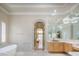 Luxurious bathroom with a soaking tub, marble accents, and vanity at 2041 Troon Dr, Henderson, NV 89074