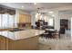 Open kitchen flows into the dining area, featuring a granite island with cooktop at 2041 Troon Dr, Henderson, NV 89074